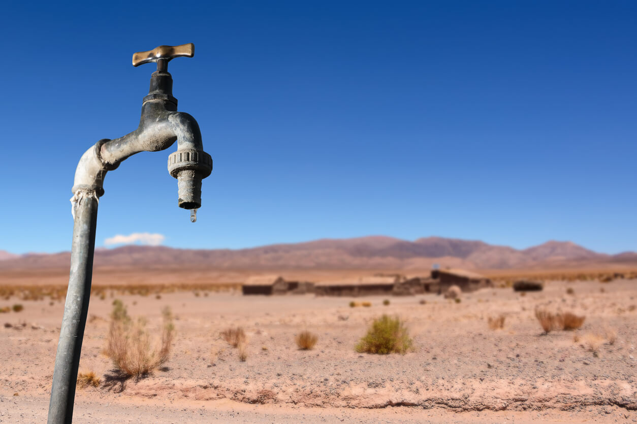 Drips faucet and dry environment in the background